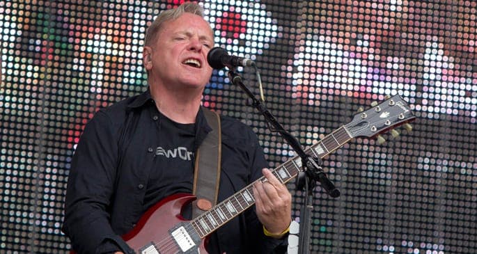 New Order’s Bernard Sumner fractures leg, carries on tour regardless
