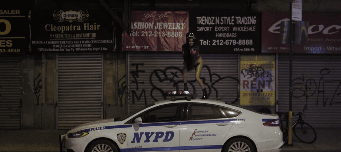 Azealia Banks dances on an NYPD car in the video for ‘The Big Big Beat’