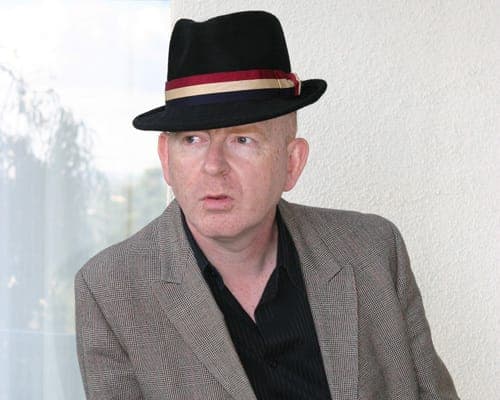 Alan McGee may be returning to the music business to “cause chaos in the world of Simon Cowell”