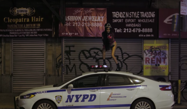 Azealia Banks dances on an NYPD car in the video for ‘The Big Big Beat’
